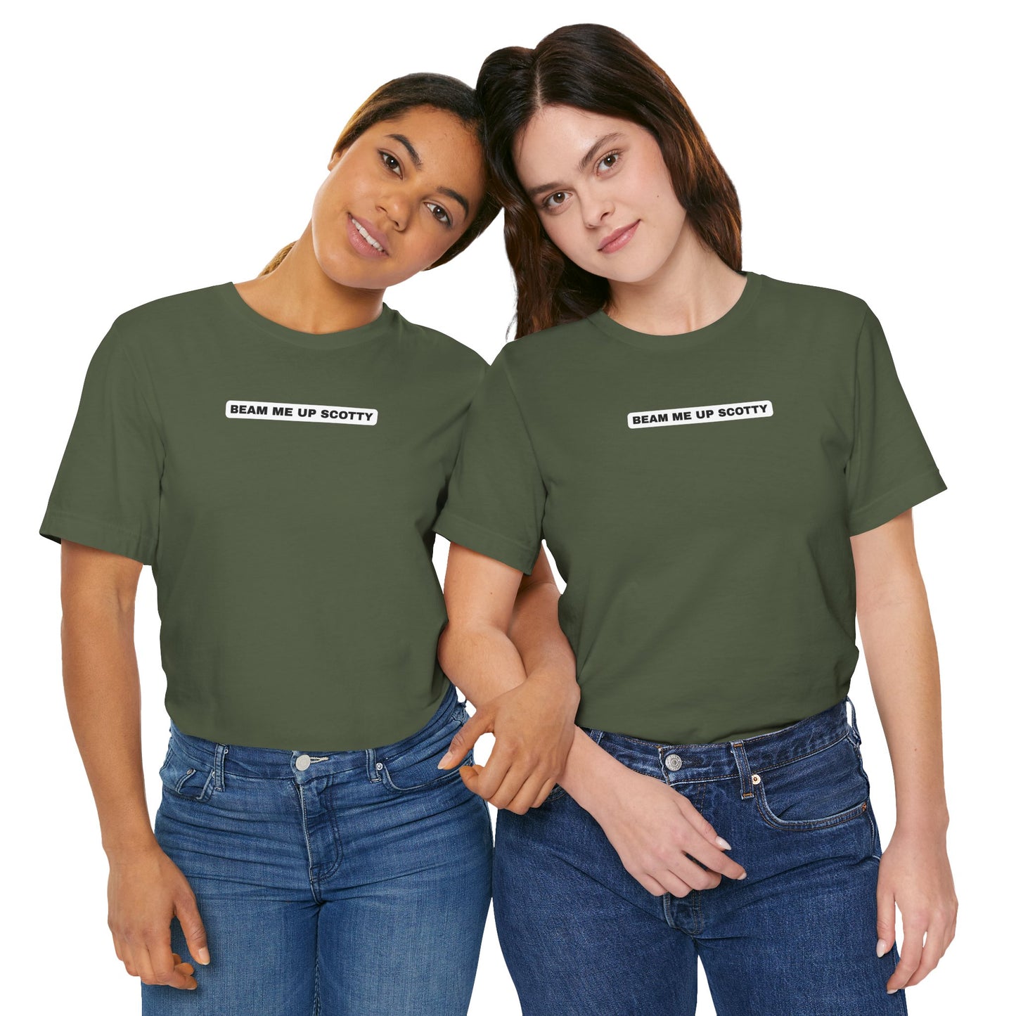 Two women wearing army green Beam Me Up Scotty Mandela Effect t-shirts tucked in, arms linked, showing unisex fit and styling