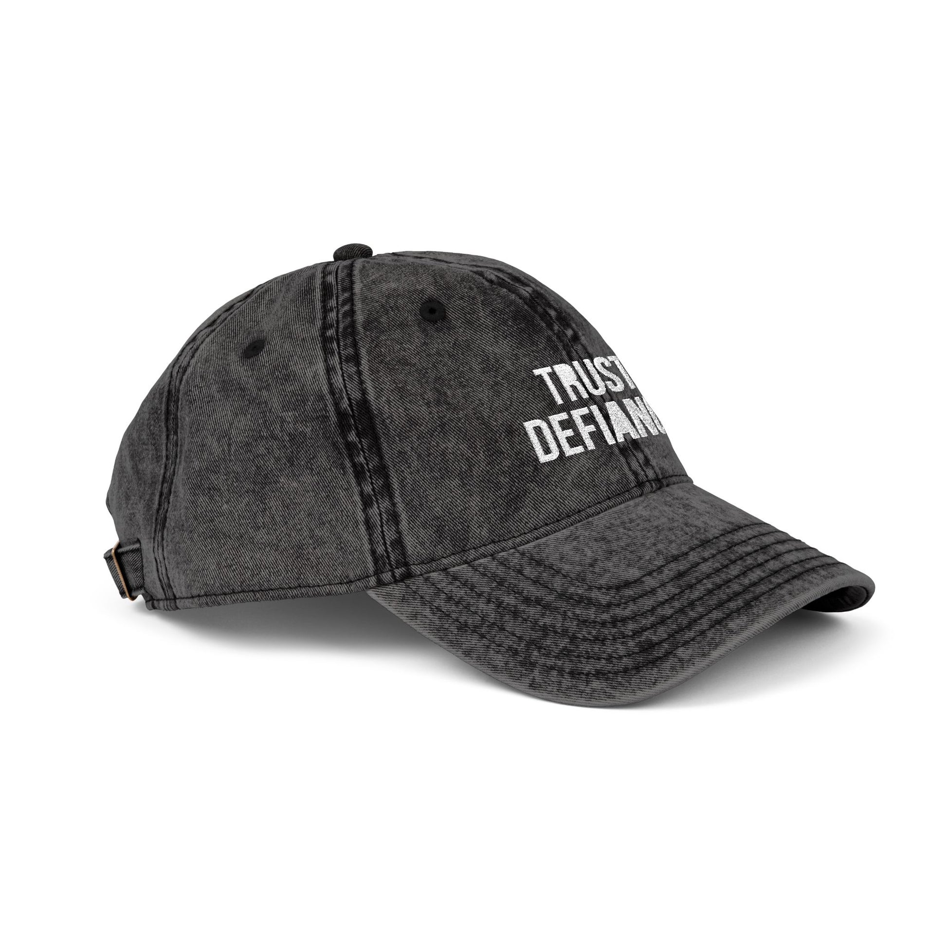 Black denim cap with 'TRUST DEFIANC' text on a white background side view