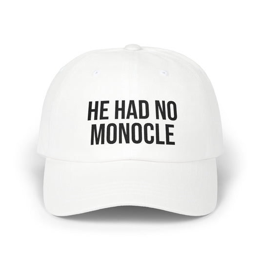 White cap with black text 'HE HAD NO MONOCLE' on a white background
