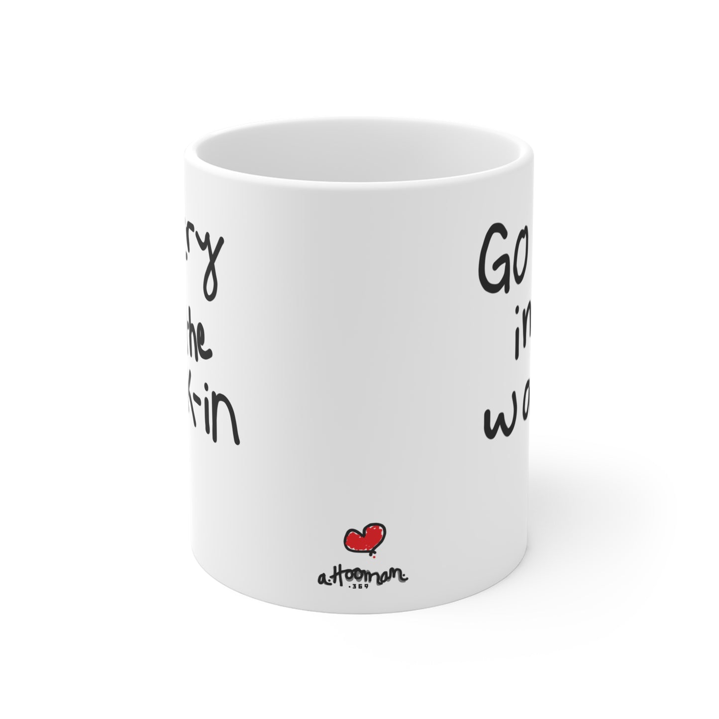 White mug with black text and a red heart by a.hooman on a white background