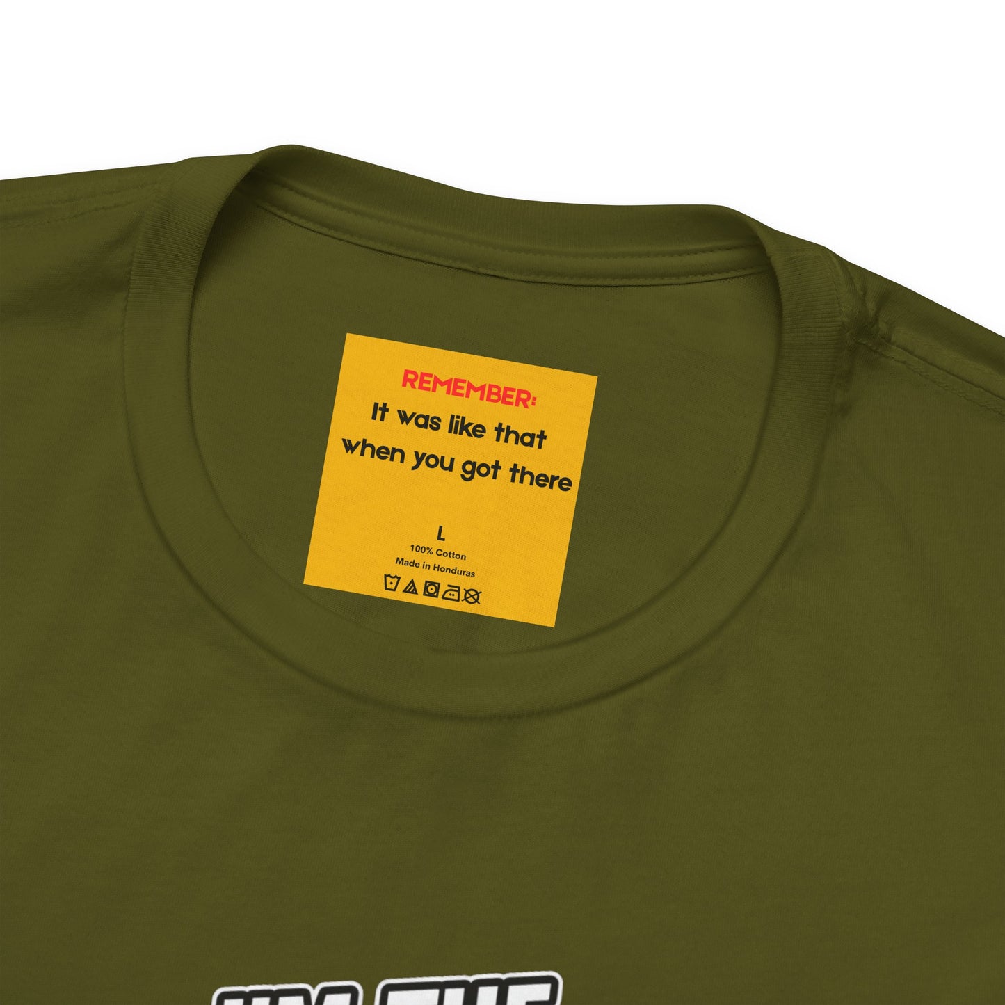 Close-up of hidden message on neck label reading 'remember: it was like that when you got there' on olive green carpenter work shirt
