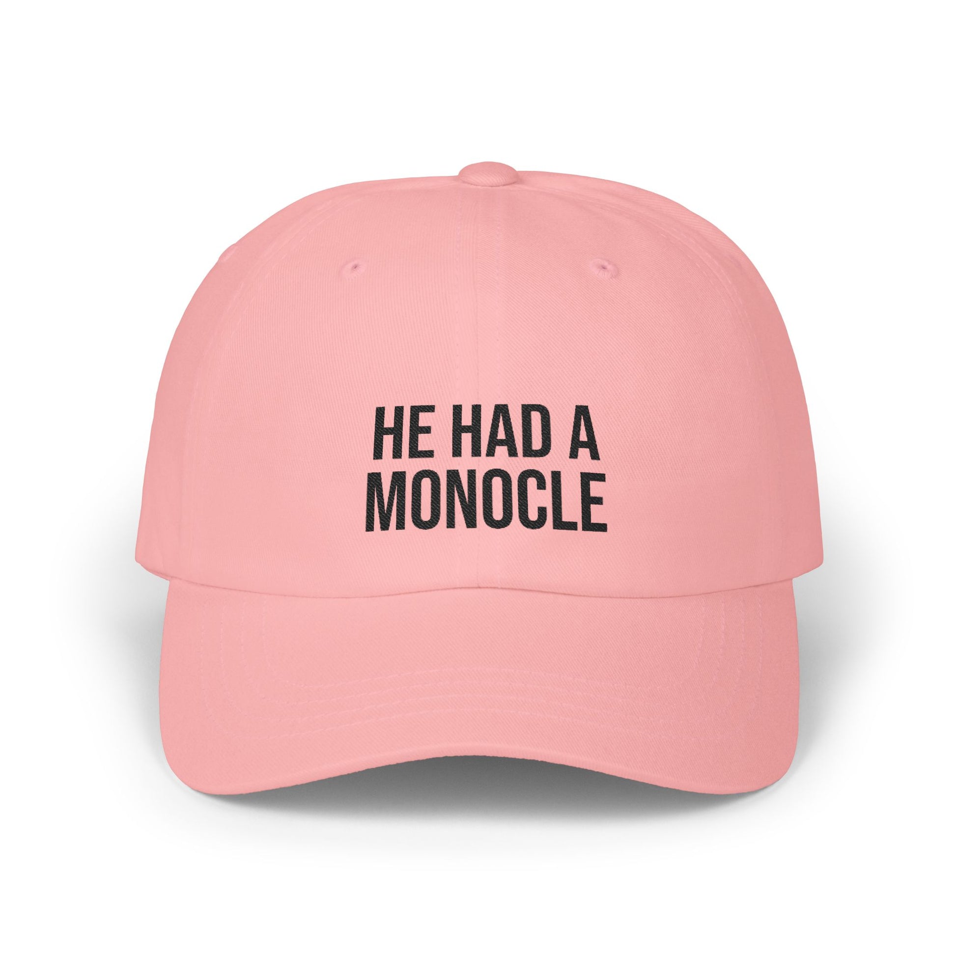 Pink cap with 'HE HAD A MONOCLE' text on a white background