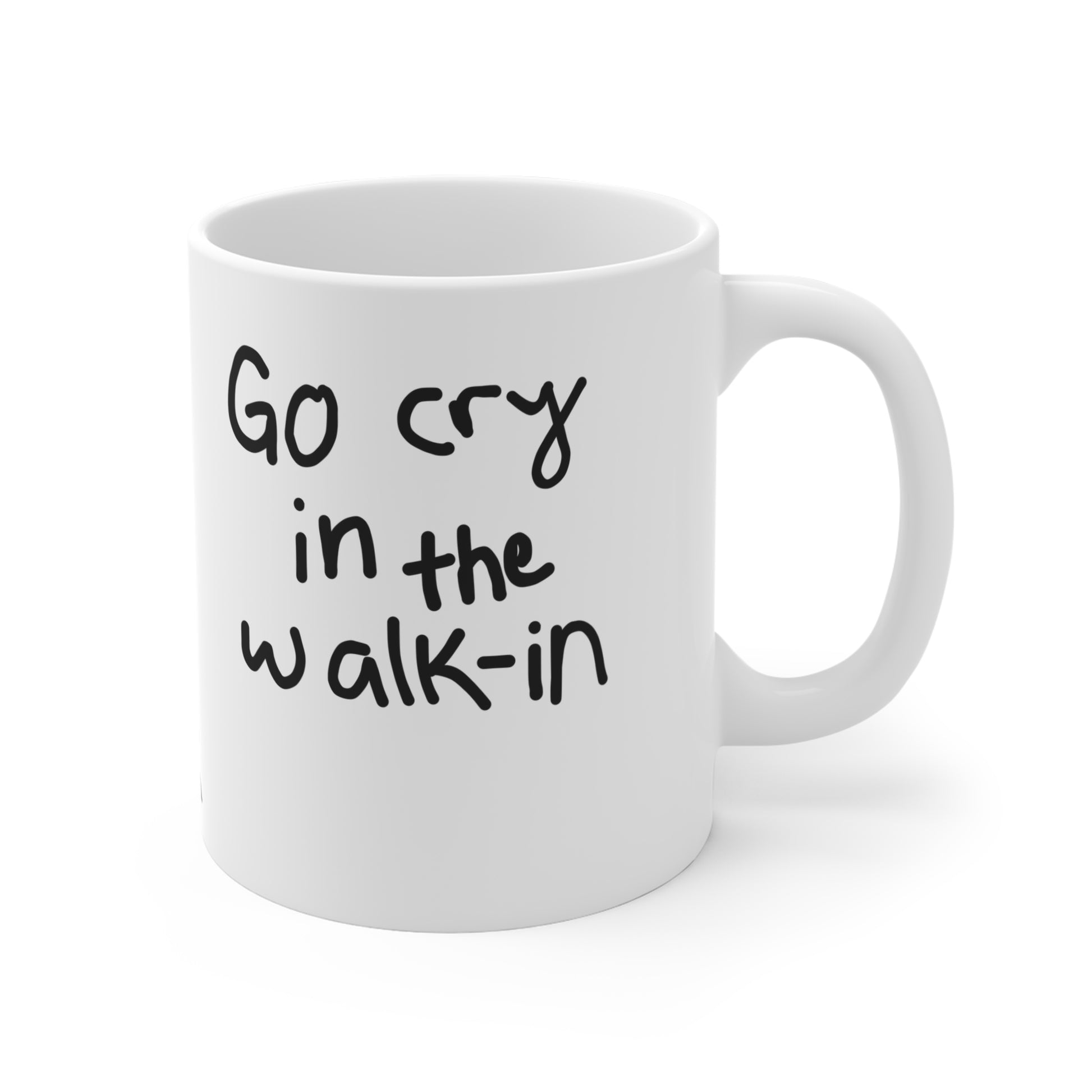 White mug with black text 'Go cry in the walk-in' on a white background