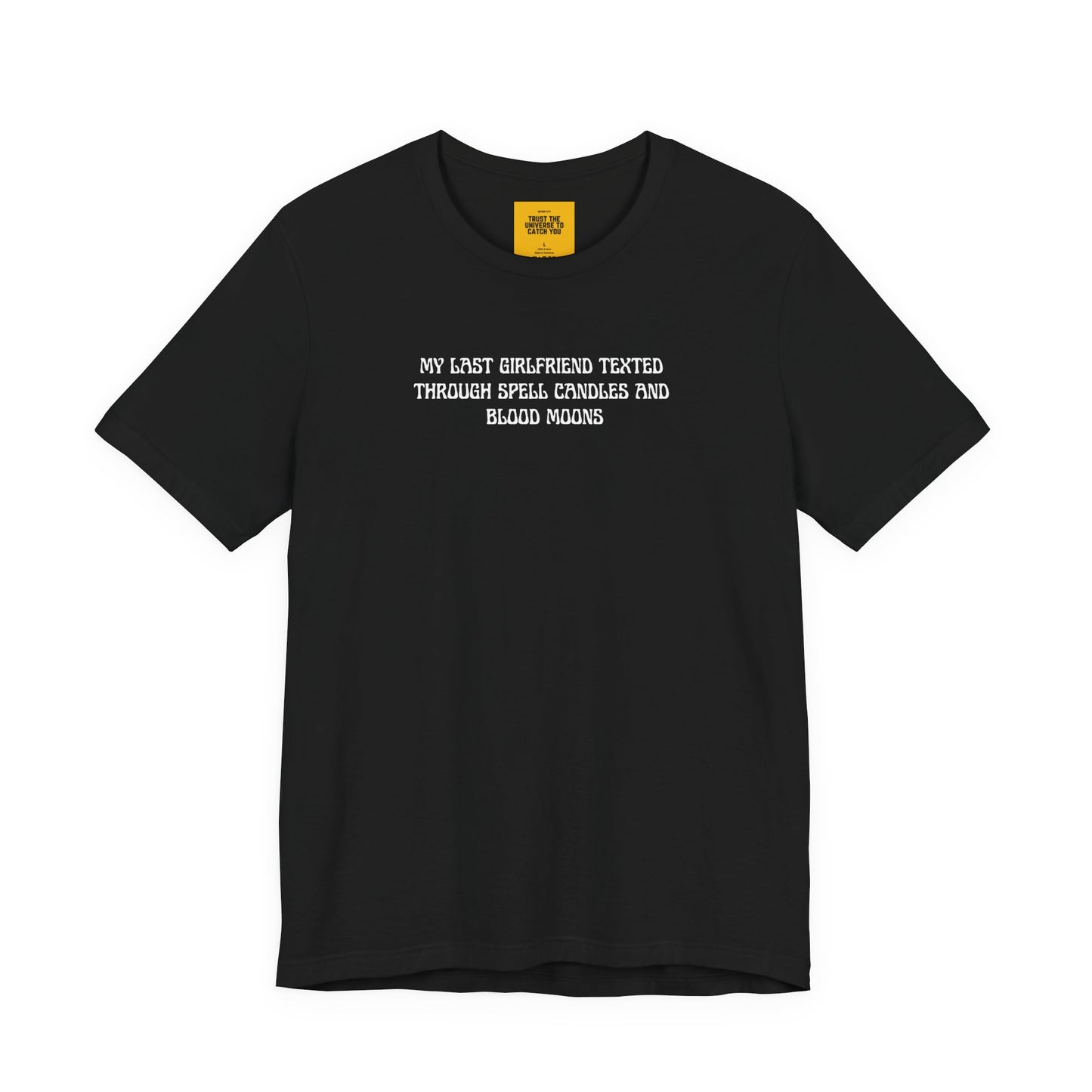 Black t-shirt with white text MY LAST GIRLFRIEND TEXTED THROUGH SPELL CANDLES AND BLOOD MOONS on a white background with Trust the Universe to catch you neck label