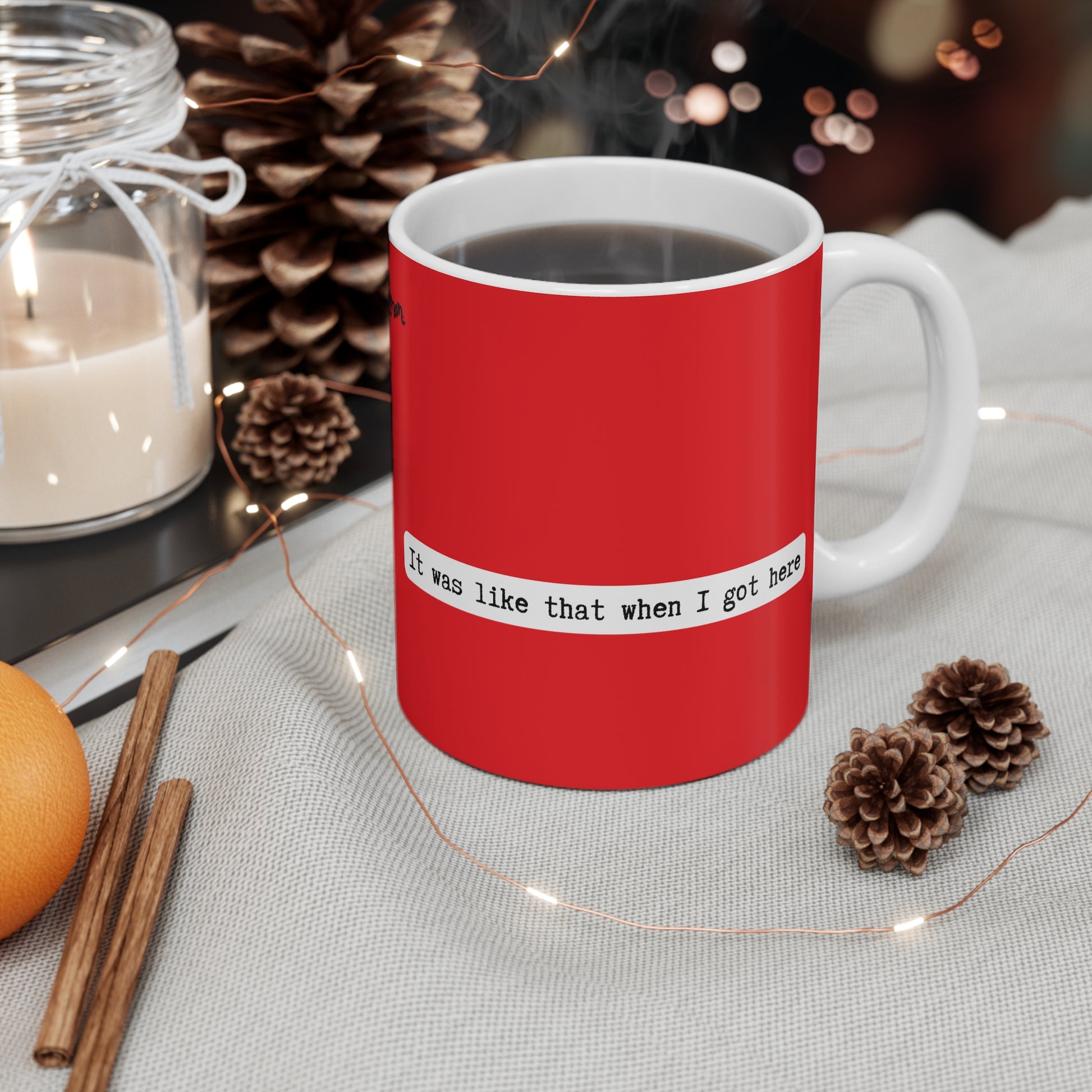Red mug with a quote on a table with decorative items