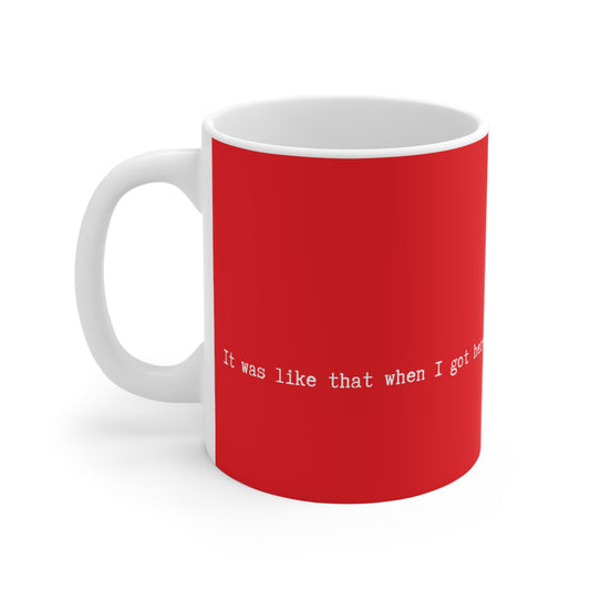 Red mug with white text on a white background