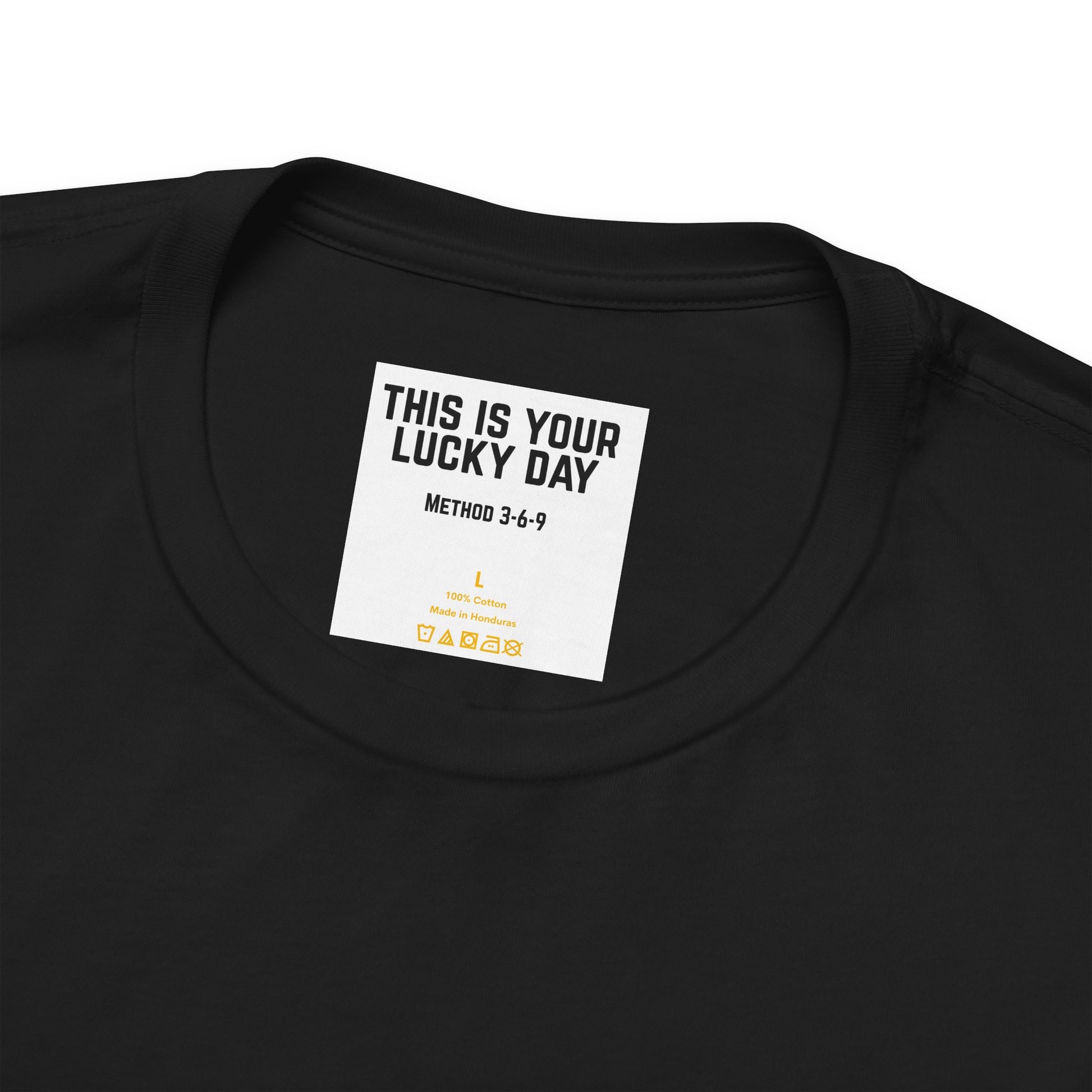 Close-up detail of neck label with text THIS IS YOUR LUCKY DAY on black Bella Canvas 3001 tee