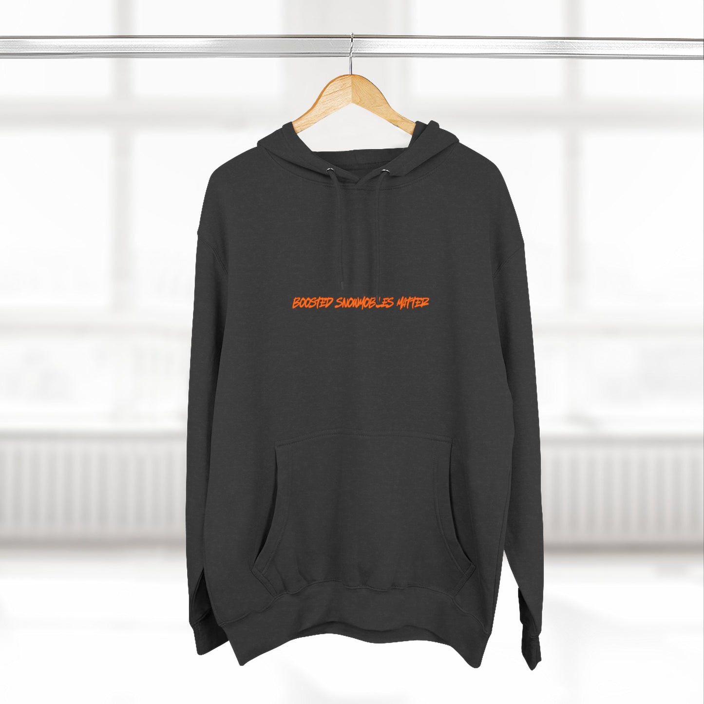 black BOOSTED SNOWMOBILES MATTER graphic hoodie with orange text  - eco-friendly turbo sled life streetwear- on hanger