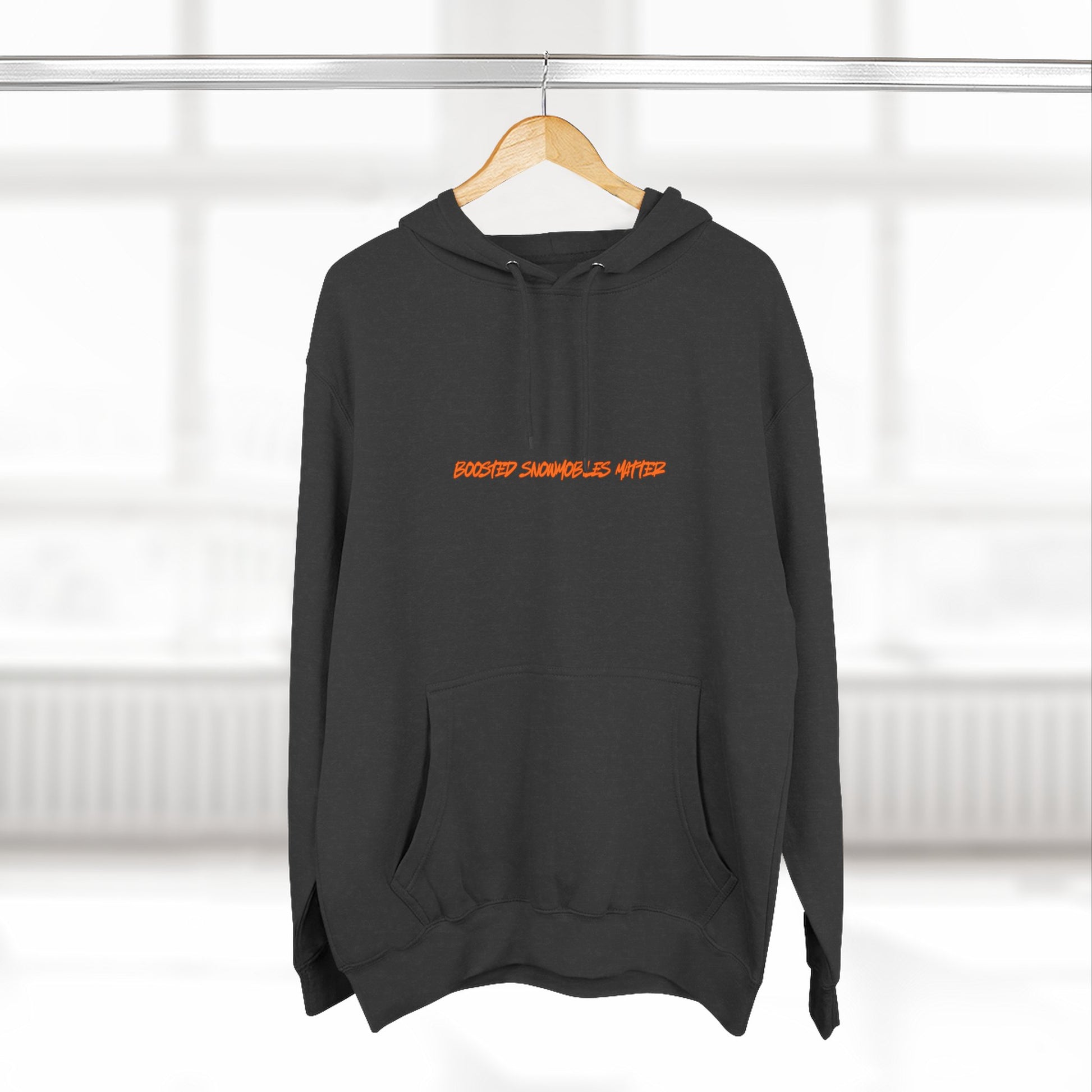 black BOOSTED SNOWMOBILES MATTER graphic hoodie with orange text  - eco-friendly turbo sled life streetwear- on hanger