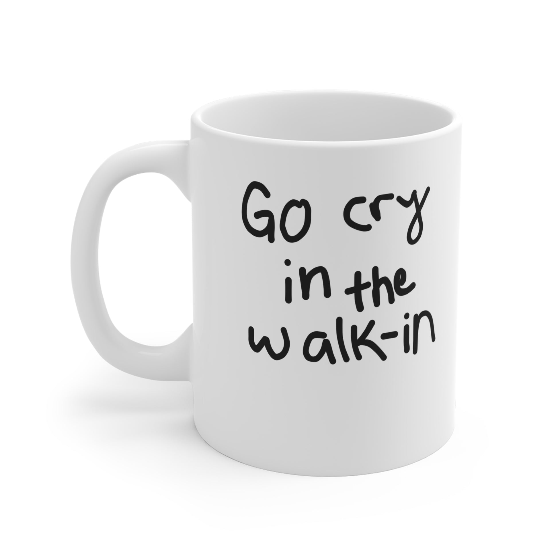 White mug with black text 'Go cry in the walk-in' on a white background