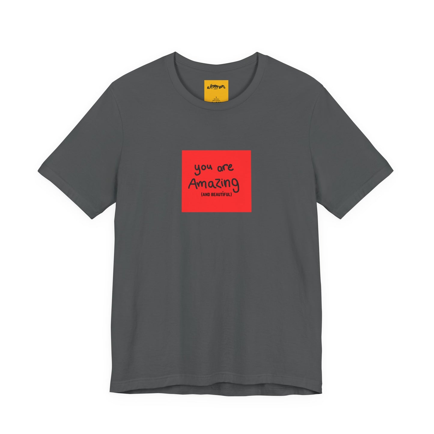 grey t-shirt with a red square and text  reads you are amazing and beautiful on a white background