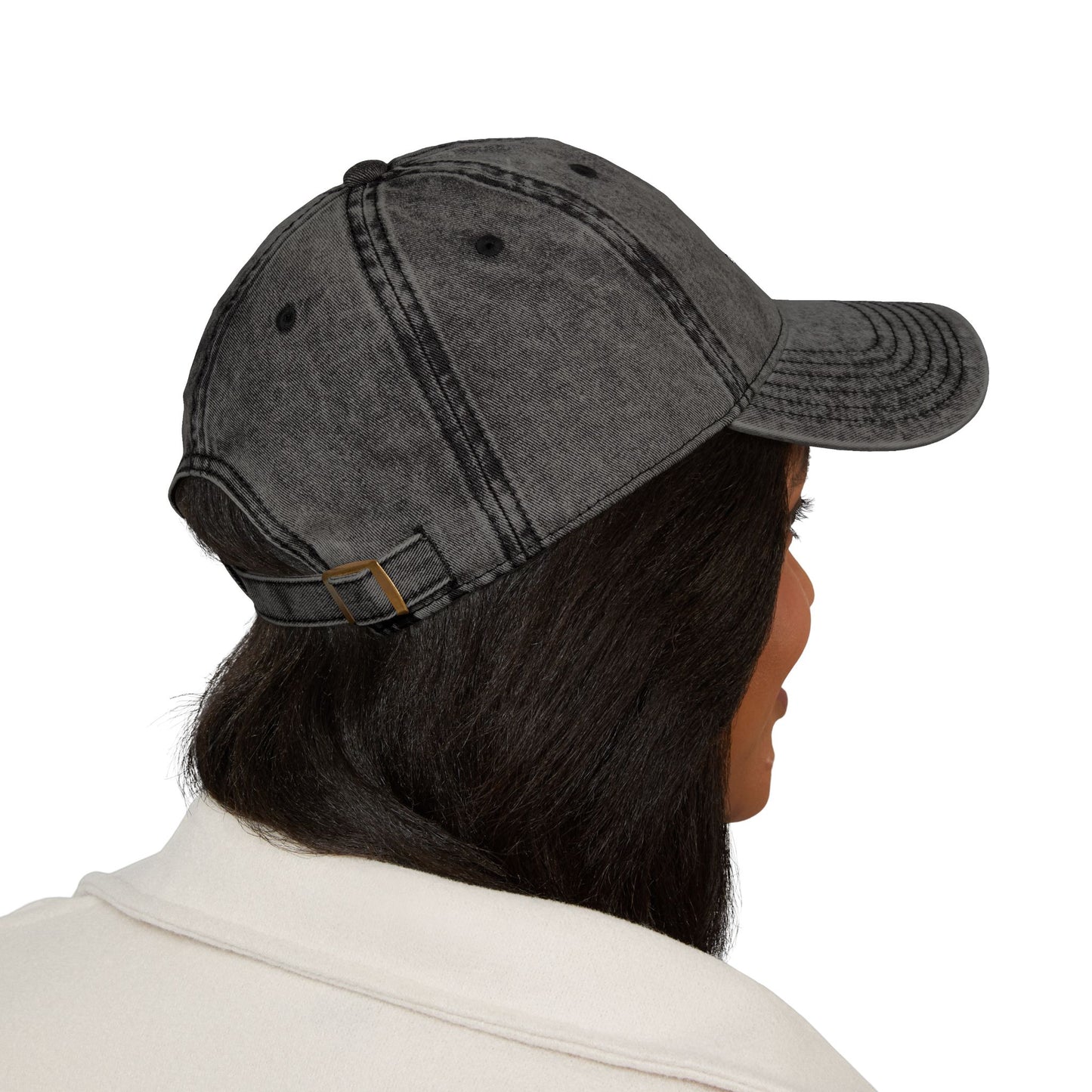 Person wearing a gray denim cap on a white background