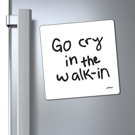 Magnet with text 'Go cry in the walk-in' attached to a refrigerator door.