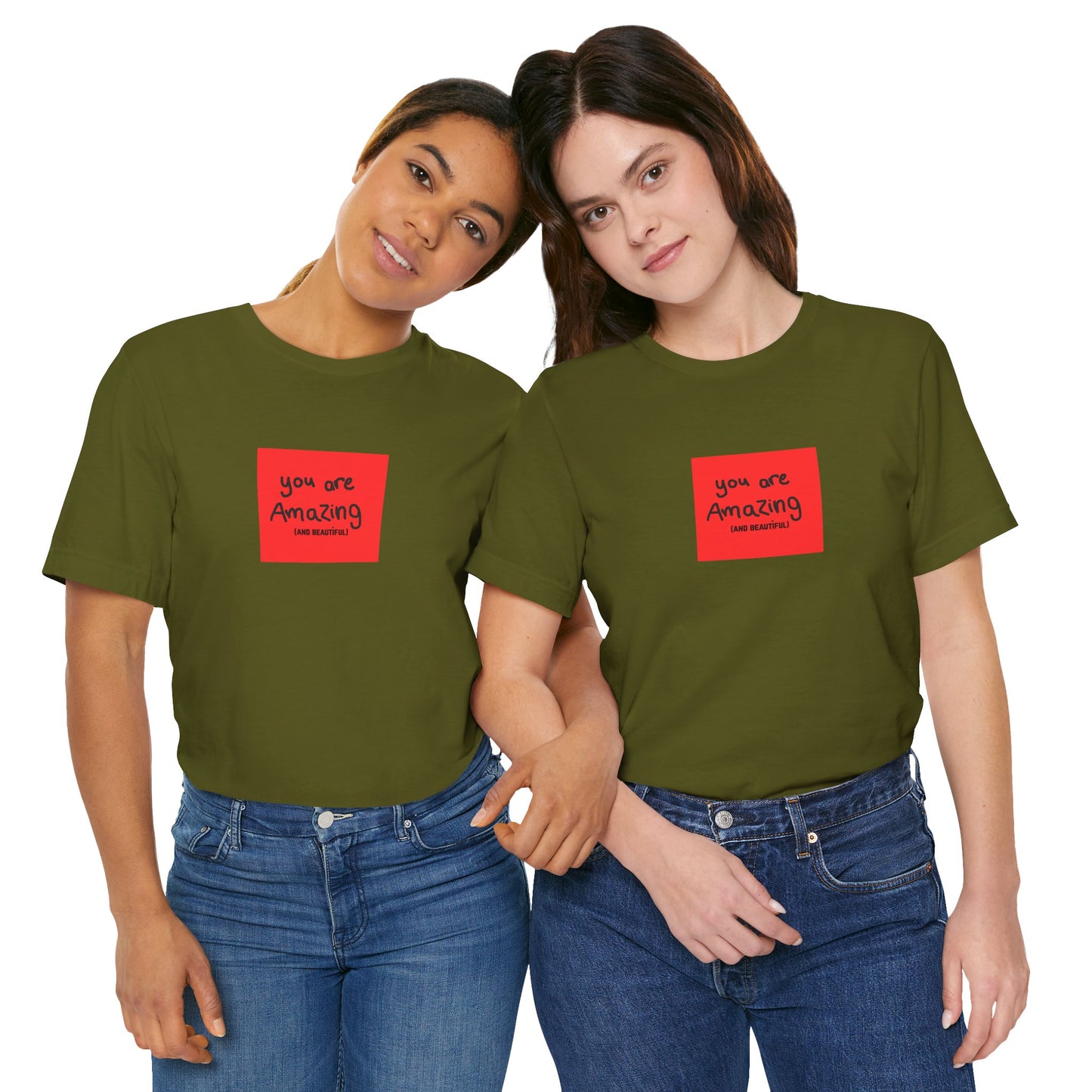 Two people wearing green t-shirts with a red square design and text.