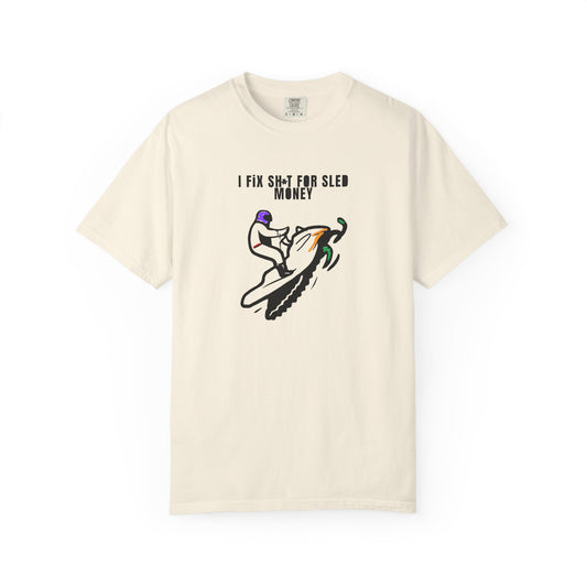 beige  t-shirt with snowmobile graphic design and text on a white background