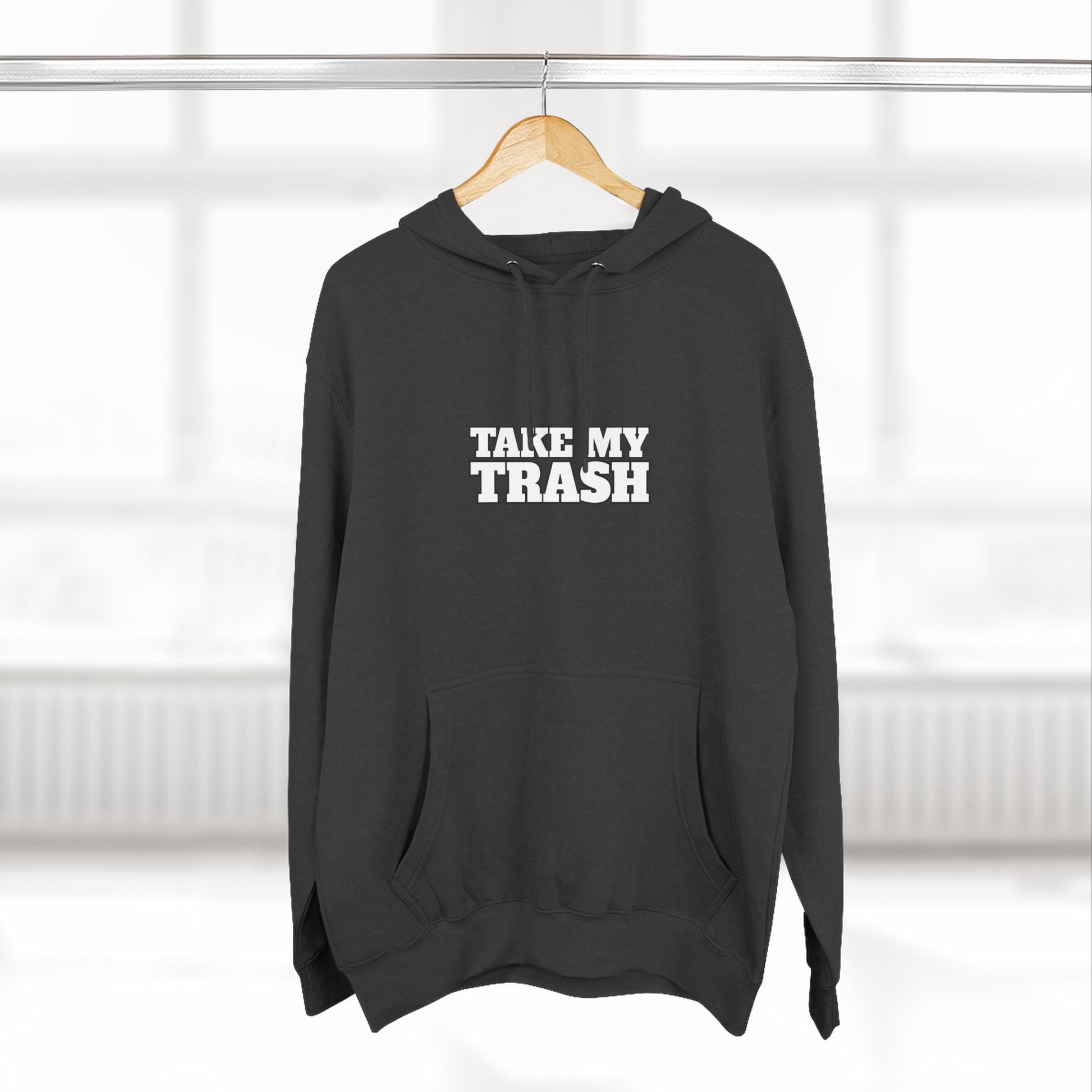Black pullover hoodie with TAKE MY TRASH text - funny breakup hoodie anti-Valentine's on hanger