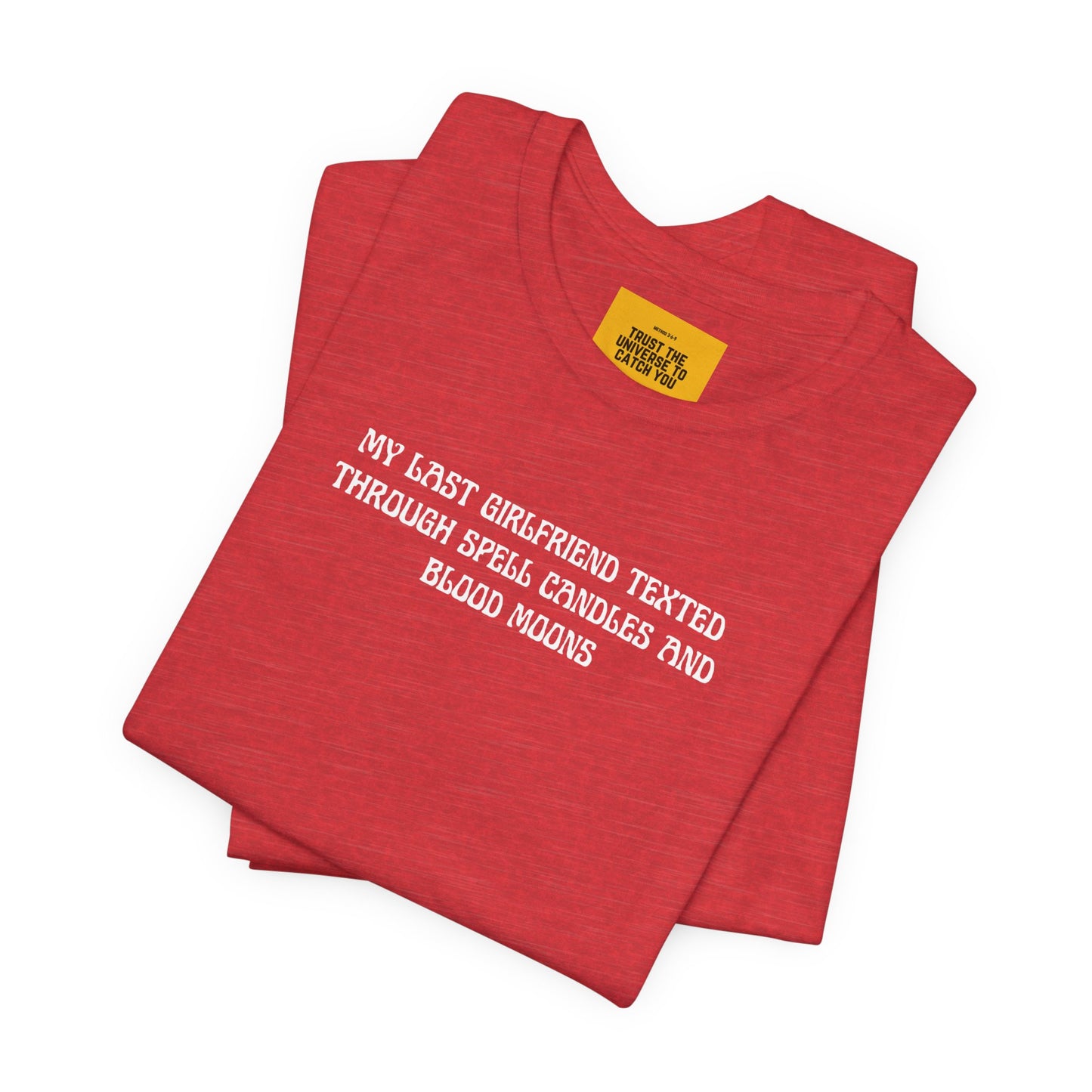 Folded red t-shirt with white text on a white background 