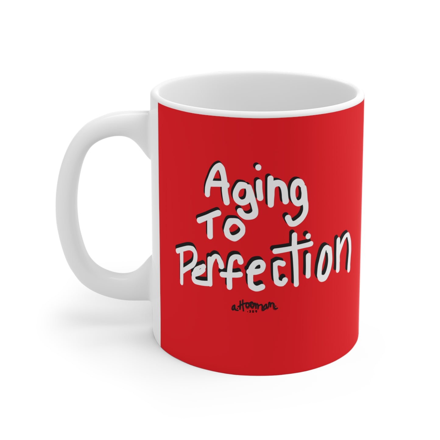 Red mug with 'Aging to Perfection' text on a white background